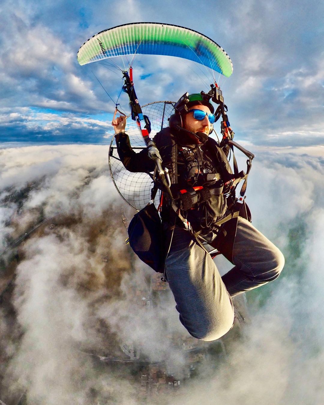 Paramotor flying over landscape